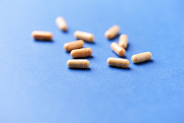 Lutein capsules. Dietary supplement on bright background. Soft focus. Close up. Copy space	