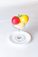 coloured ice cream in a glass bowl on a white background isolated
