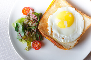 Homemade breakfast scrambled egg sandwich with tomatoes cherry on white table, healthy breakfast fried egg on toast with fresh and nutritious ingredients