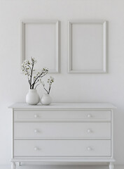 A mockup of two blank black frames on the wall above an elegant white dresser, with soft morning light casting gentle shadows, creating a serene and stylish home interior scene