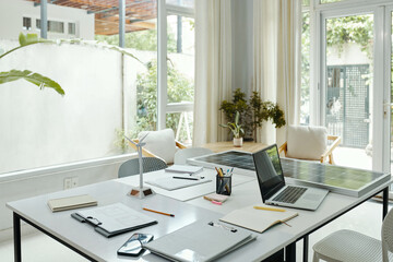Meeting table with documents and solar panel in board room