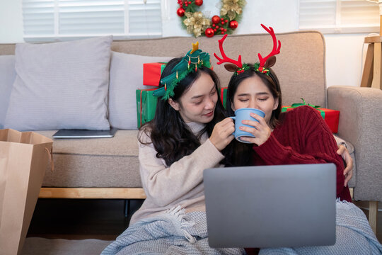 Multiracial Couple Sharing Coffee During Online Christmas Gathering