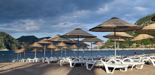 Sunbeds and umbrellas on the beach of Icmeler. Marmaris