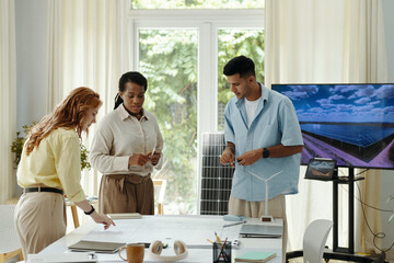 Group of engineers planning work of green energy in team during meeting in office © DragonImages