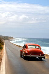 Vintage car cruising along a coastal highway