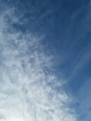 Blue sky and feathery clouds.