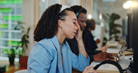 Woman, employee and tired at office with headache, exhausted and overworked as technician consultant. Female person, call center agent and burnout at workplace with fatigue for customer support