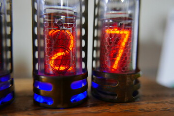 Retro Nixie lamp indicator clock on dark background. The Nixie tube indicator of the numbers of...