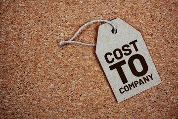 Cost To Company text on price tag top view on cork paper background