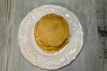 Top view of a stack of golden brown pancakes.