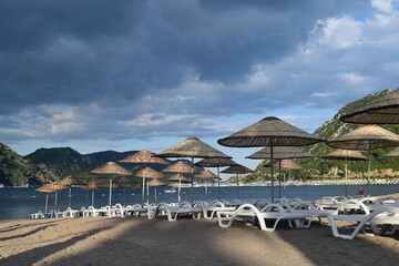 Sunbeds and umbrellas on the beach of Icmeler. Marmaris
