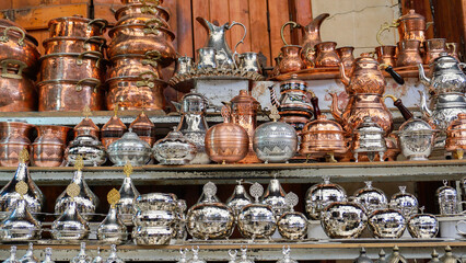Traditional Copper and Silver Utensils Displayed in Market