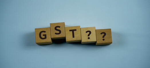 GST?? Concept Words on wooden blocks. Idea for healthcare, typography, medical, business and financial concept. Copy space for mockup, marketing and background