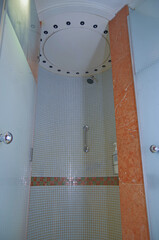 Turkish bath or steam sauna with mosaic tiles inside male locker room of spa or wellness are...