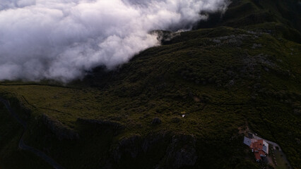 Aerial View of Lush Green Mountains and Rolling Clouds