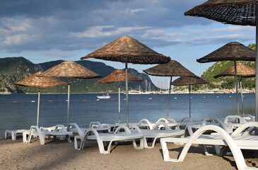 Sunbeds and umbrellas on the beach of Icmeler. Marmaris
