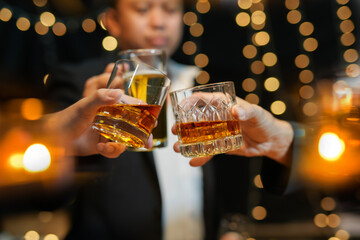 food and drink male friends are happy drinking beer and clinking glasses at a bar or pub.
