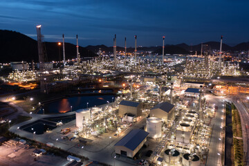 Aerial view oil and gas storage tank, oil refinery factory plant at night form industry zone, Oil refinery petrochemical plant factory at twilight, 