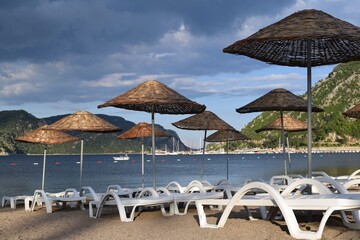 Sunbeds and umbrellas on the beach of Icmeler. Marmaris