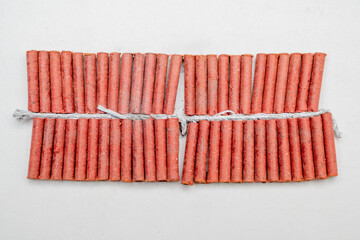 Red fire crackers string isolated over white background