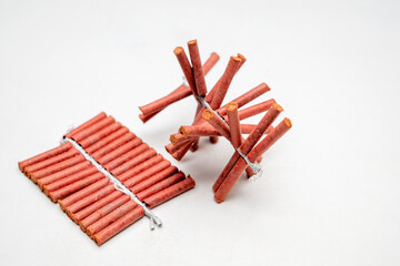 Red fire crackers string isolated over white background
