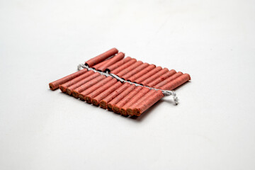 Red fire crackers string isolated over white background