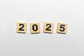 Obraz premium Wooden blocks with number 2025 on white background