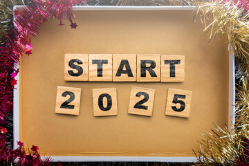 Wooden blocks with text of start 2025 in the gift box
