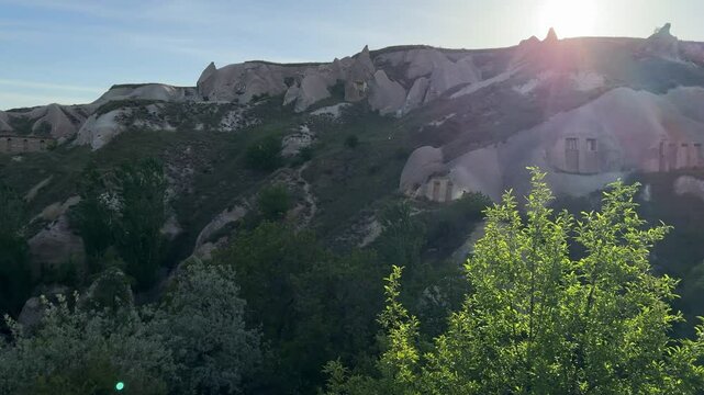 Rock caves and the cityscape of Uchisar (belde) on a sunny day in Nevsehir in Cappadocia, Turkey