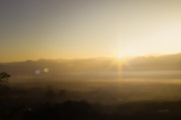 Abstract blurring warm colors and bright sunlight. Bokeh or merry christmas winter background, happy new year 2025. Green forest nature, sky sunny light patterns evening clouds blur in Navidad.