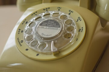 old rotary phone focusing on emergency number