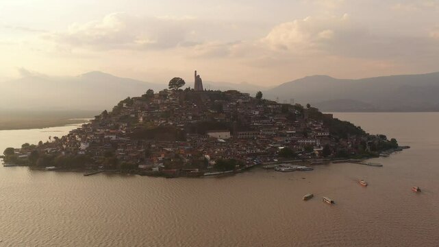 DRONE: ORBIT OF JANITZIO ISLAND AT PATZCUARO MICHOACAN AT SUNSET