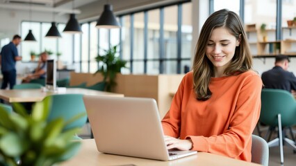 Young Woman Working on Laptop in Modern Office Space, Ideal for Business and Technology Websites