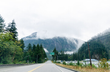 Highway in Hope  BC, Canada with cloud covered mountains in the background