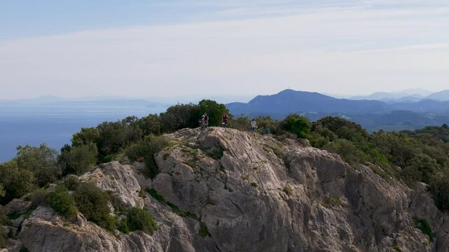 Aerial footage of tourists standing at "Ogono.Talaia gailurra" observation deck in Biscay, Spain