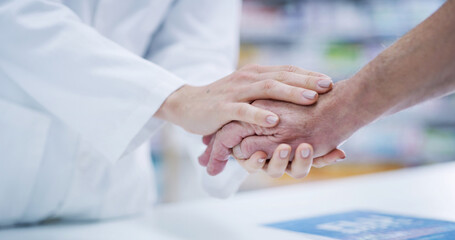Support, pharmacist and patient holding hands at counter for help, empathy and elderly healthcare...
