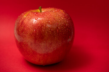 Red apple with water drops