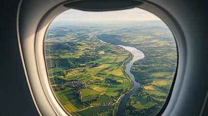 Fototapeta premium Scenic view of green fields and winding rivers from an airplane window.