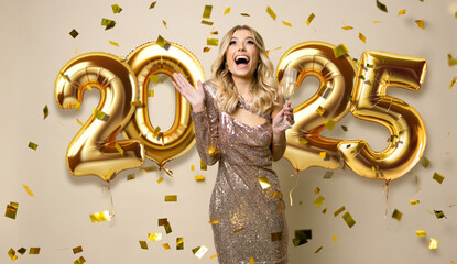 Happy New Year 2025 to you. Beautiful woman in sparkle dress standing under confetti rain with...