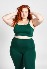 Naklejka premium Beautiful curvy plus size girl smiling on white background
