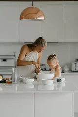 Mother and daughter preparing food in kitchen © Natalia