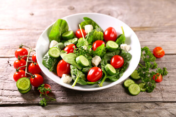 spinach salad with tomato and cucumber. healthy eating
