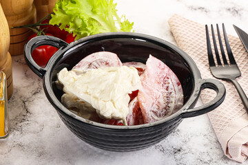 Salad with sliced tomato and stracciatella
