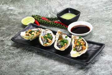 Open half oysters with green onion
