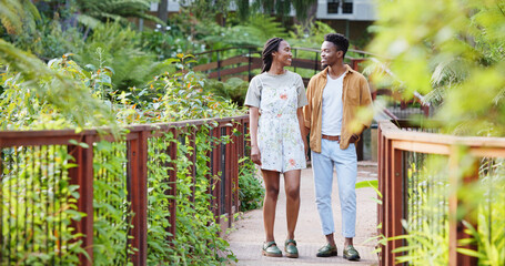 Love, walk and black couple on bridge in park for bonding, connection and outdoor adventure. Commitment, man and woman on path in nature for romantic date, weekend morning and trust in green garden.