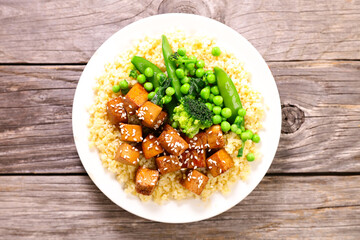 grilled tofu and sesam with bulgur and green pea. Vegan or vegetarian dish