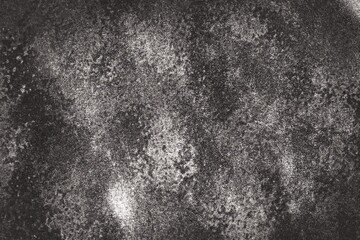 Dark gray to black background There is a pattern of spots and a rough, uneven surface. It feels raw and natural. Similar to the surface of rock or soil that has undergone erosion.