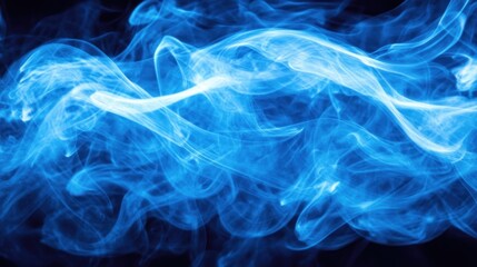 Fototapeta premium Abstract blue smoke swirling against a dark background, creating a dynamic visual effect.