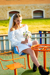 Couple of bride and groom enjoying romantic moments in wedding ceremony at playground, Love, celebration and marriage. High quality photo