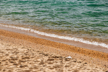 the sandy shore of Lake Baikal at sunset